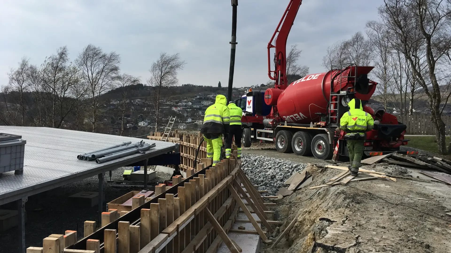 Pour day: the pump feeding the ring wall from the mixer truck.