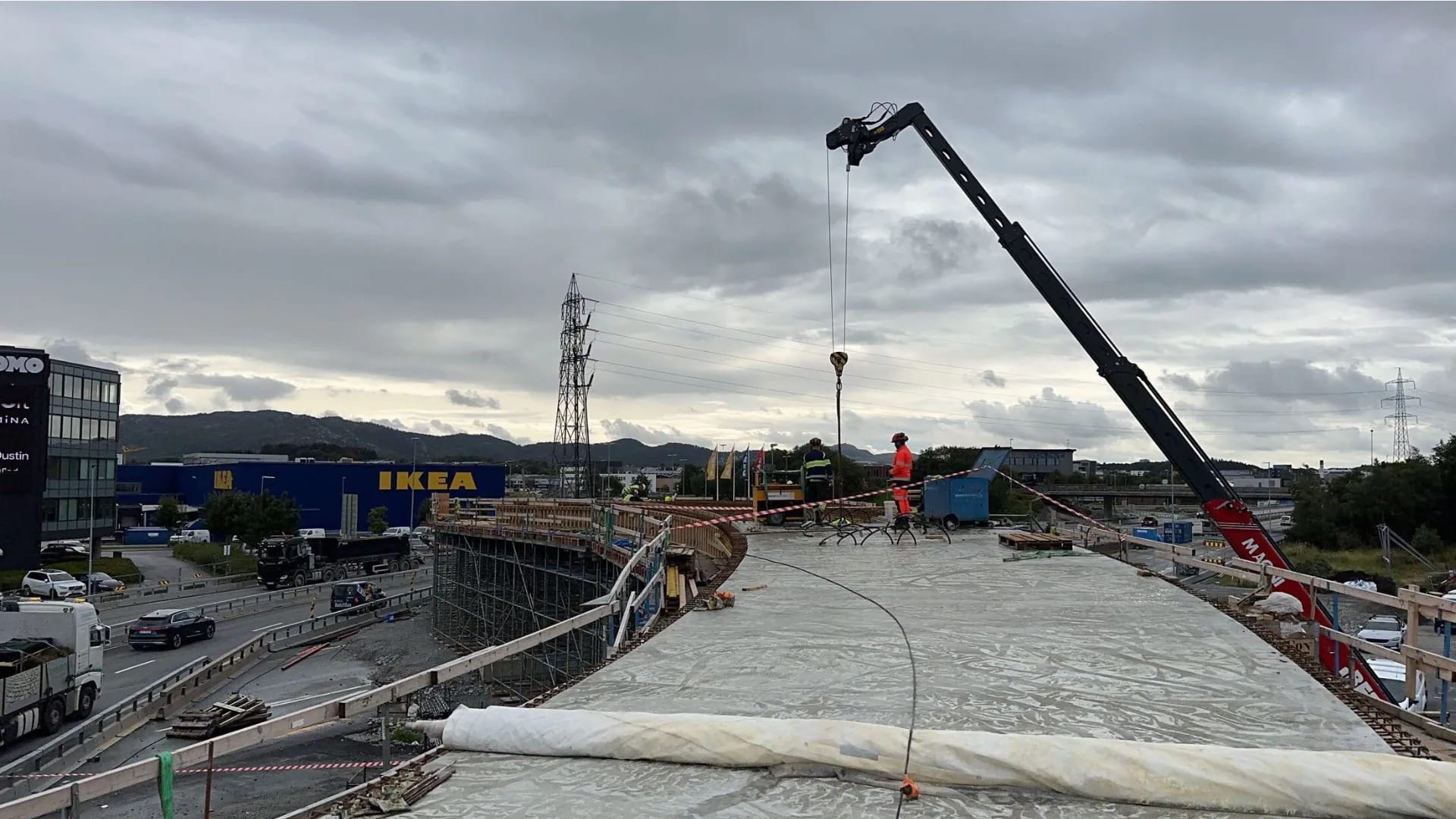 A freshly cast bridge deck under curing covers, ready for the next stage.